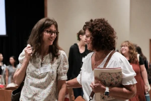 Two women who seem to be having a conversation while talking to each other. 